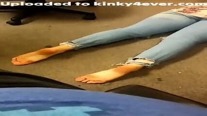 Dark Haired Woman In Blue Jeans Poses Barefoot On The Floor