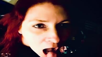Redhead milf on her knees sucking cock and takes the cum in her mouth and continues to suck his cock with a load in her mouth